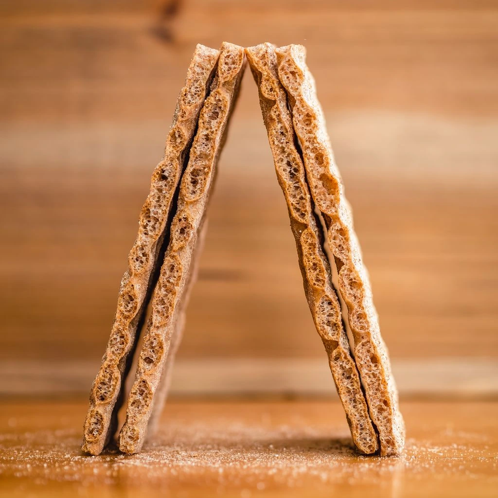 Stack of branded kraft cookie sleeves on a marble slab
